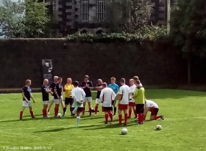 The opposing sides have a pre-match gossip before kicking the ball around